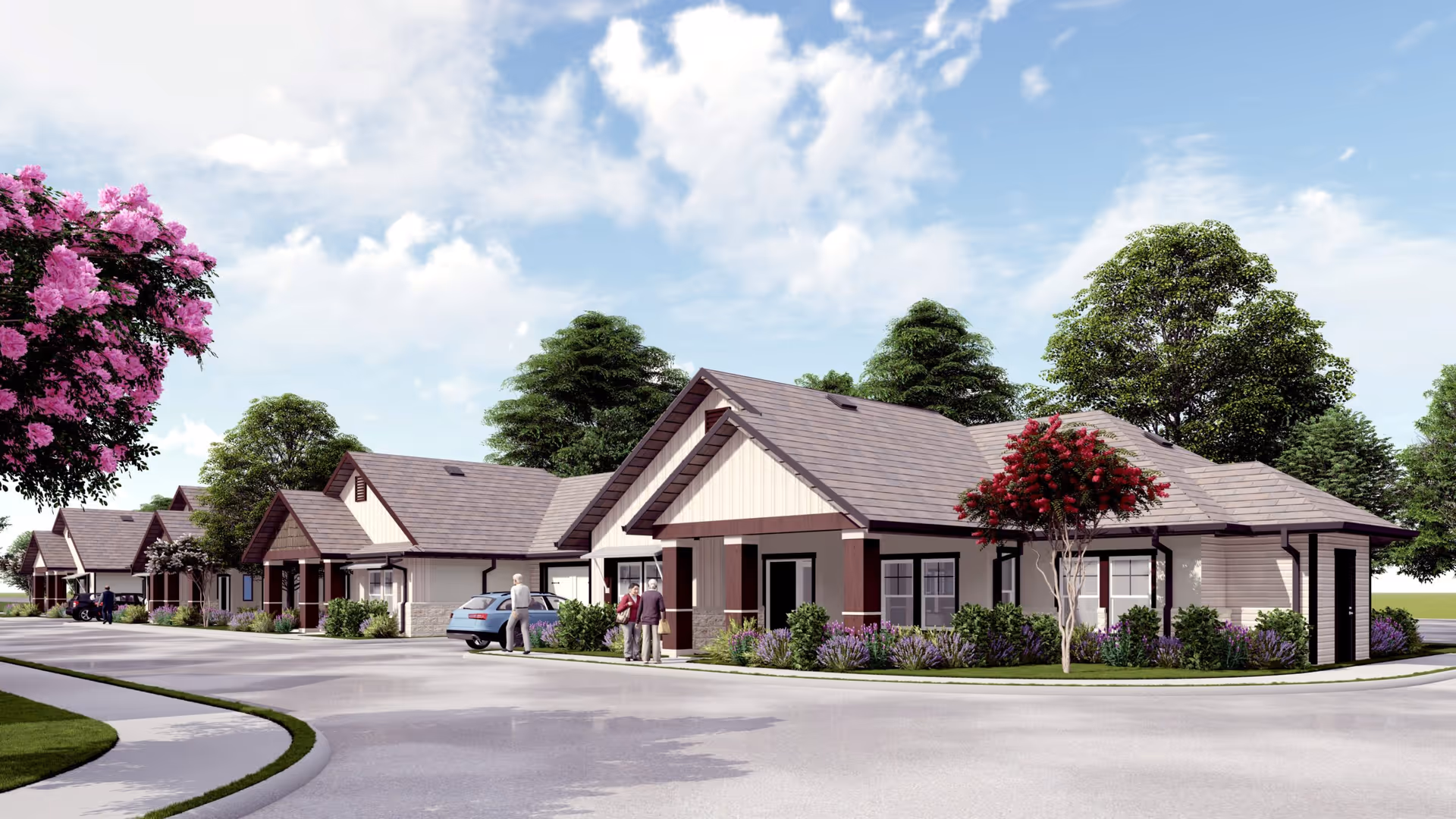 Exterior view of Woodland Cottages Senior Living Fredericksburg showing a row of single-story cottages with pitched roofs, surrounded by trees and flowering bushes, with a few elderly people standing near a parked car on a curved driveway under a partly cloudy sky.
