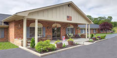 Exterior view of Salem West Healthcare Center with brick facade and potted plants.