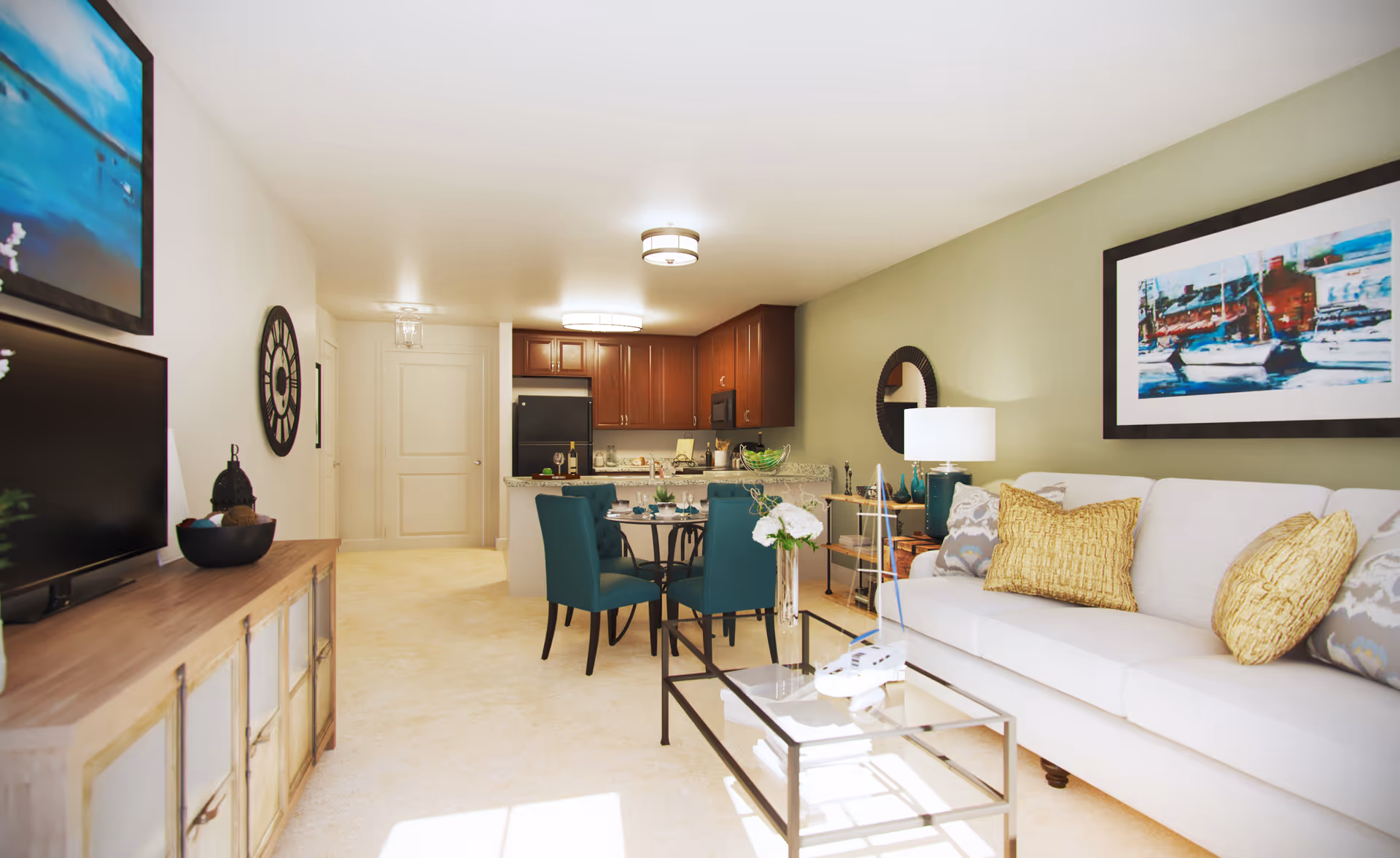Bright open living room with a white sofa, glass coffee table, teal dining chairs and a view into a kitchen with dark wood cabinets.