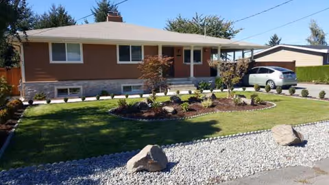 Sunset Home Care facility exterior: single-story brick building with a manicured lawn and landscaped front yard.