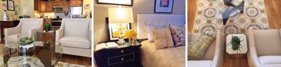 Three views of a cozy living area and bedroom in a senior living facility. The first view shows two beige armchairs with nailhead trim around a glass coffee table with a small plant, with a kitchen visible in the background. The second view shows a bedside table with a lamp, a vase of yellow flowers, and a bed with multiple pillows. The third view is a top-down perspective of two beige armchairs with a small table between them holding a plant, a patterned rug, and a folded yellow blanket on the floor.