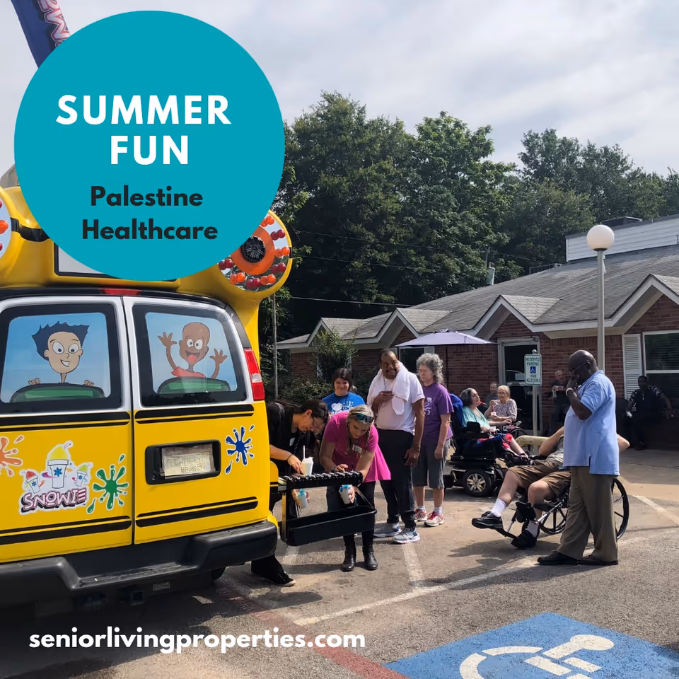 Residents and staff gather outside Palestine Healthcare around a colorful snow-cone truck during a summer event.