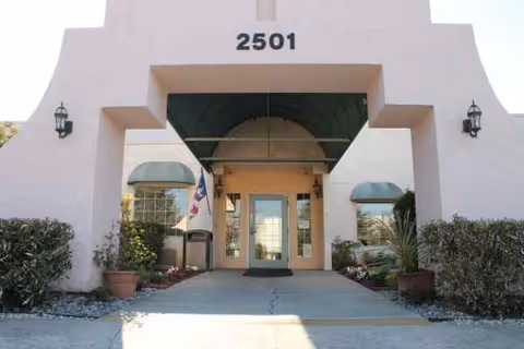 Facade of Mission de la Casa Nursing and Rehabilitation Center with arched entrance and planters.