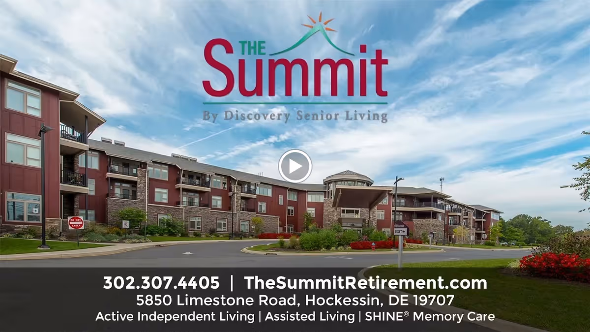 Exterior front view of The Summit senior living building with the facility logo and contact info overlaid.