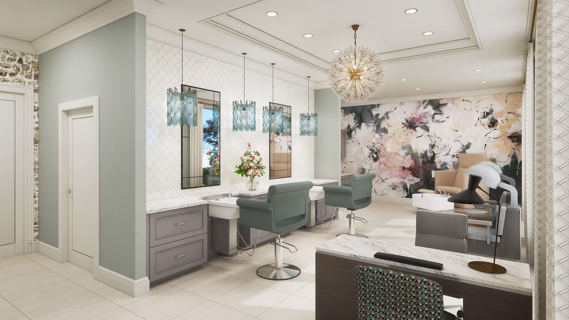 A modern salon area in a senior living facility featuring two green salon chairs in front of mirrors with pendant lights above. There is a reception desk with a patterned chair and a lamp, and a seating area with armchairs and a floral abstract mural on the wall in the background.