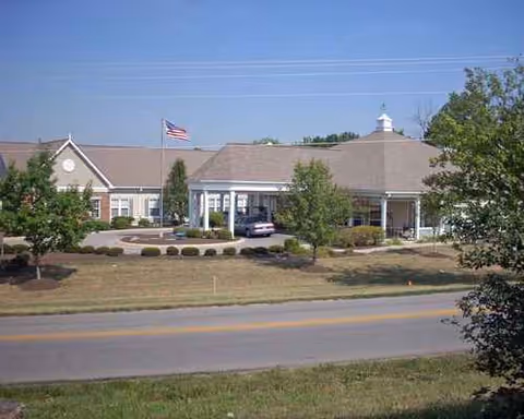 Exterior of Morning Pointe of Frankfort with flag, entrance, and surrounding landscaping.