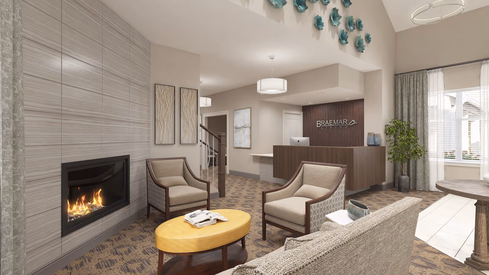 A cozy senior living facility lobby with a modern fireplace on the left, two beige armchairs, a yellow oval coffee table with magazines, and a beige sofa. The reception desk with a computer is visible in the background with the Braemar Living logo on the wall. The room has neutral tones, patterned carpet, decorative wall art, a potted plant near a window with curtains, and soft overhead lighting.
