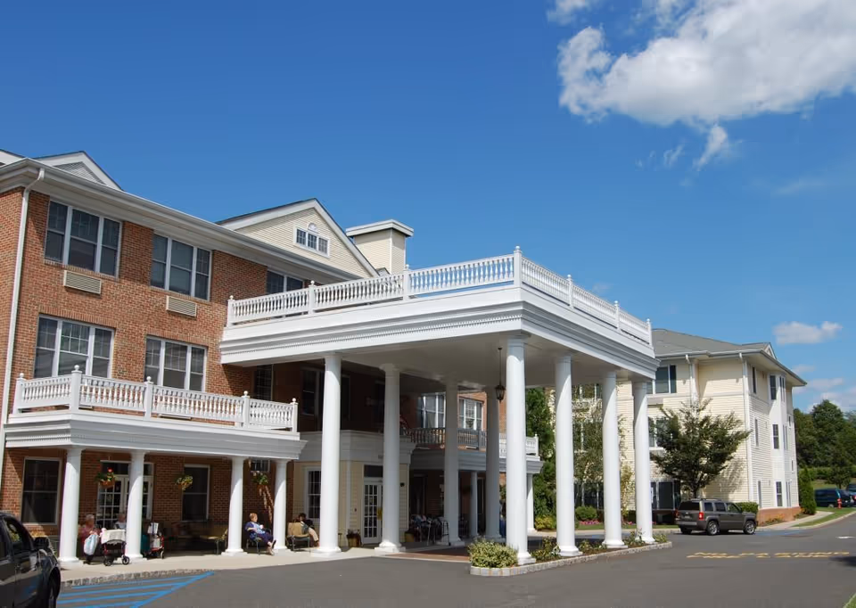 Exterior view of the Mira Vie at Green Knoll assisted living facility featuring a portico with columns.