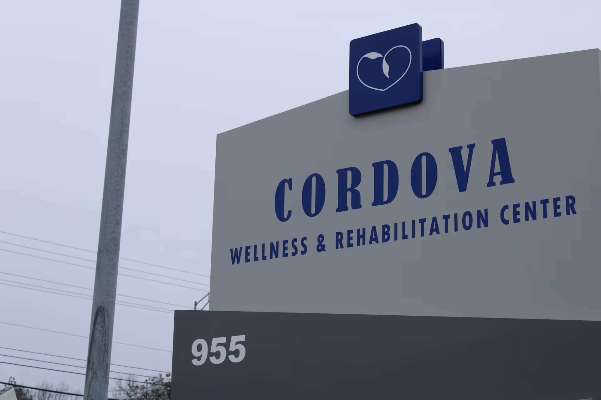Outdoor sign displaying 'CORDOVA Wellness & Rehabilitation Center' with a heart logo and the number 955.