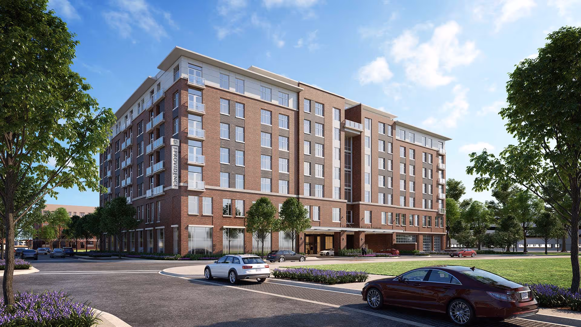Seven-story brick senior living building with landscaped grounds, parked cars and trees under a blue sky.