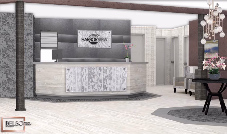 Modern reception desk and lobby area with a 'Harbor View' sign, seating, and decorative plants.