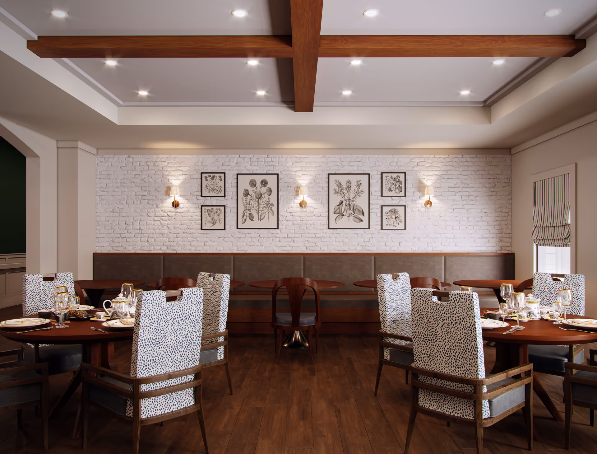 A dining room with wooden floors and round wooden tables set with plates, glasses, and silverware. The chairs have patterned upholstery with a white and black spotted design. The back wall features white painted brick with framed botanical prints and wall sconces. The ceiling has wooden beams and recessed lighting.