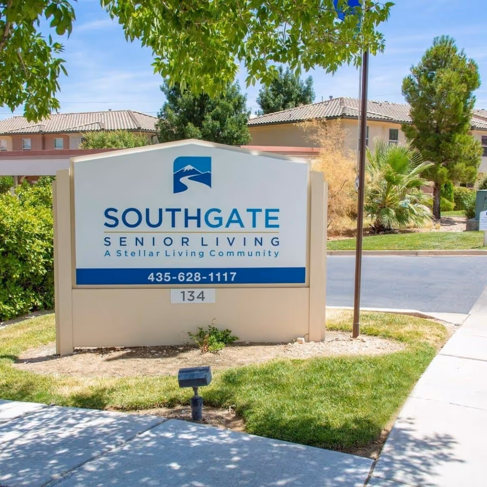 Outdoor sign reading "Southgate Senior Living" in front of landscaped grounds and the facility buildings.