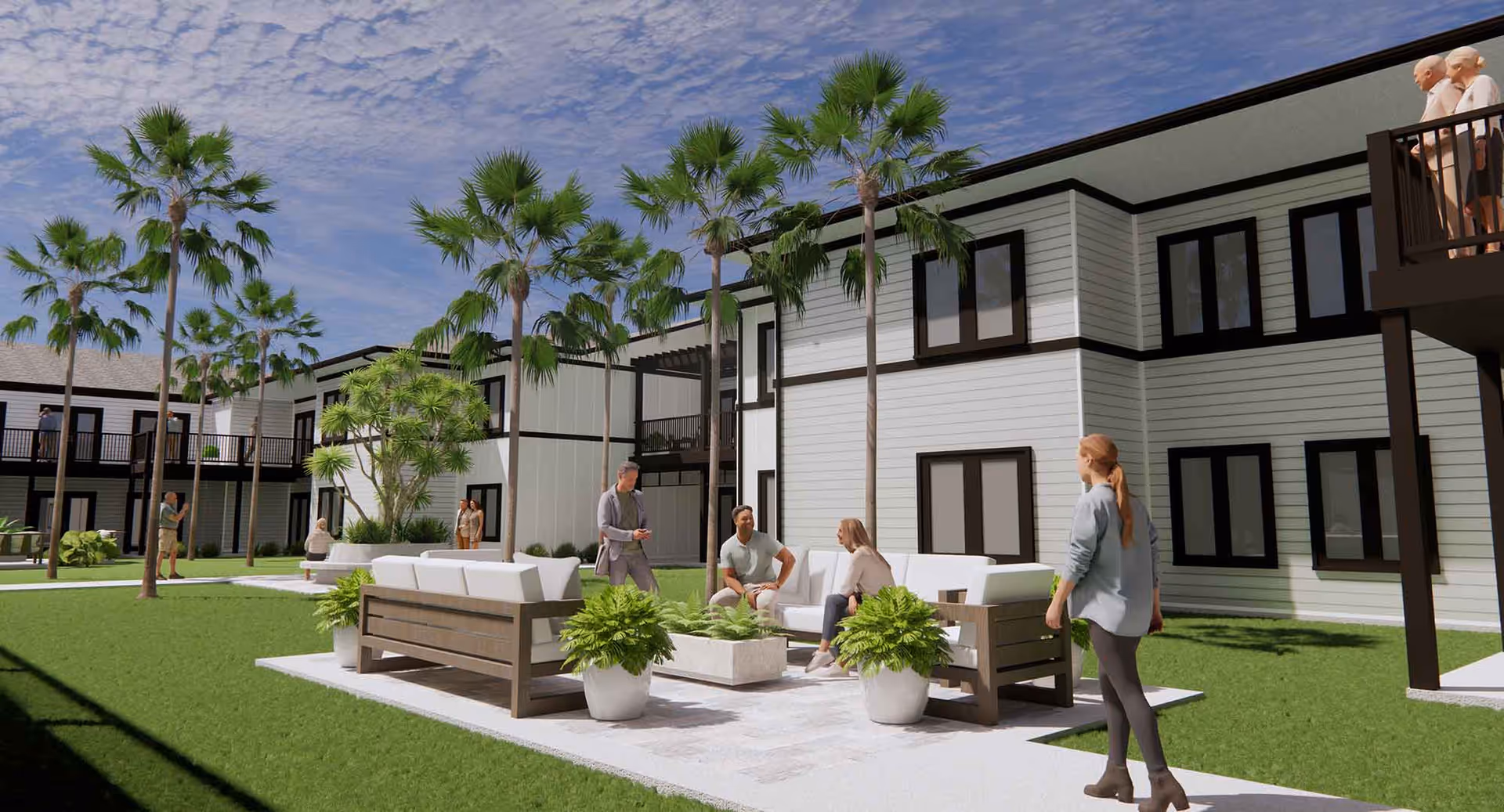 Outdoor courtyard area of a senior living facility with palm trees, green grass, and modern white and wood outdoor seating. Several people are seen walking and sitting, enjoying the sunny day. The building is two stories with white siding and black window frames, featuring balconies on the upper floor.