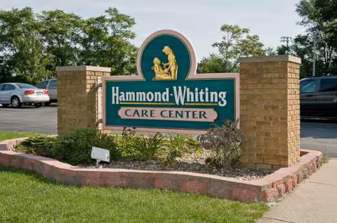A Hammond-Whiting Care Center sign sits at a landscaped entrance with brick pillars