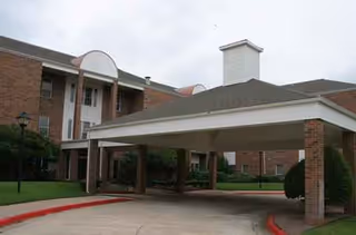 Exterior view of Rivermont Independent Living building with a covered entrance.