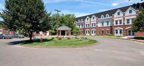 Exterior view of Addison Place at Glastonbury showing circular driveway and landscaped island.