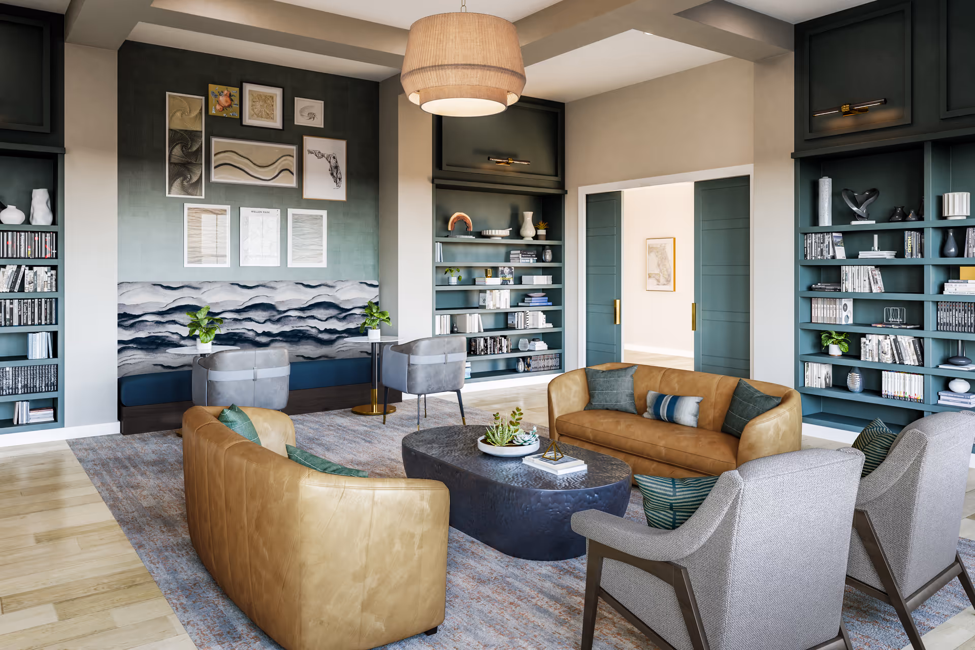 A modern living room with two tan leather sofas, two gray armchairs, and two gray chairs with small tables against a wall with built-in shelves filled with books and decorative items. The room features a large area rug, a dark oval coffee table with plants and books, and a large pendant light hanging from the ceiling. The walls are decorated with framed artwork and a textured panel behind the gray chairs.