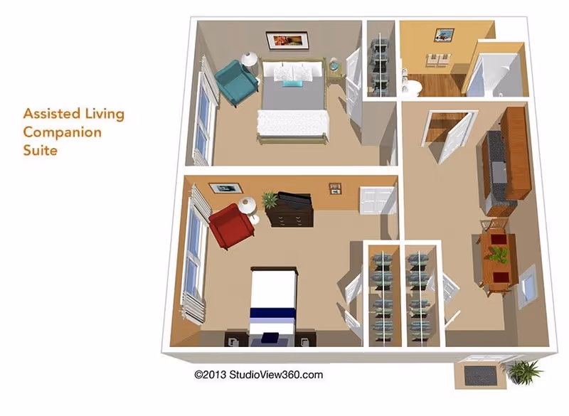 3D floor plan of an assisted living companion suite showing two bedrooms, a bathroom, closets, and a living area with kitchen and dining space. One bedroom has a bed, armchair, nightstand, and dresser, while the other bedroom has a bed, armchair, nightstand, and dresser. The bathroom includes a toilet and shower. The living area features a kitchen with appliances and a dining table with chairs. The entrance is visible with a small mat and plant outside.