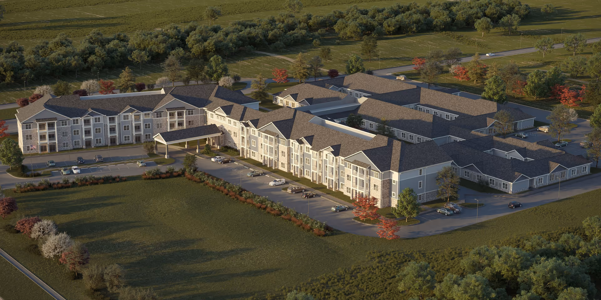 Aerial view of a large senior living campus with parking and manicured grounds.