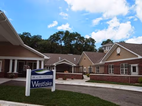 Front exterior of the Westlake Health Campus building with an entrance canopy and a lawn sign reading 'Health Center at Westlake'.