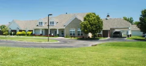 Brookdale Dodge City senior living facility with manicured lawn and driveway at the front.