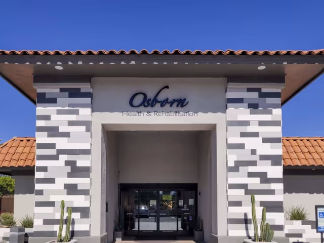 Front entrance of Osborn Health & Rehabilitation showing a tiled portico with the facility name above glass double doors.