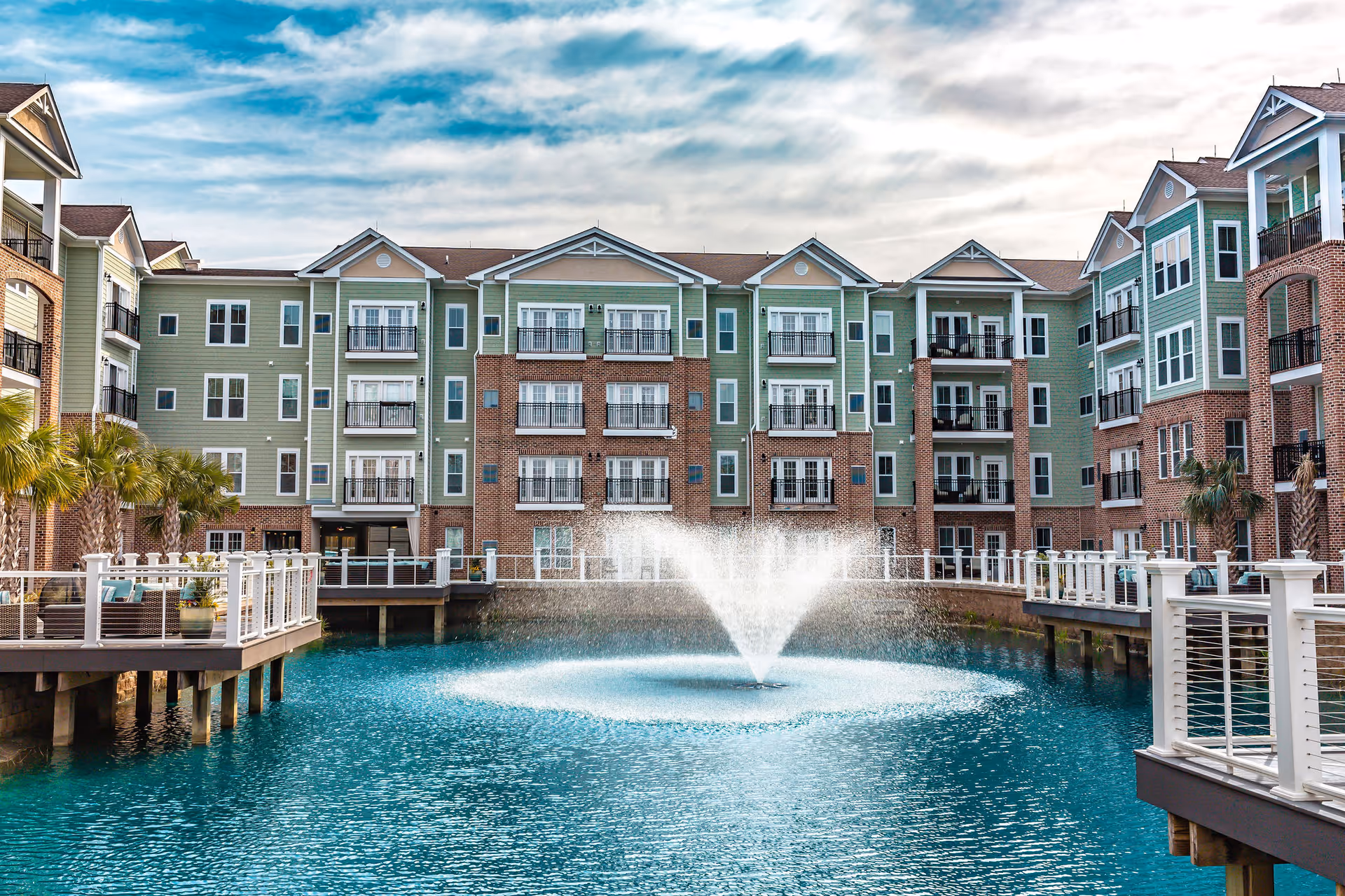 Exterior of Cambridge Village - Wilmington with a central pond and fountain.