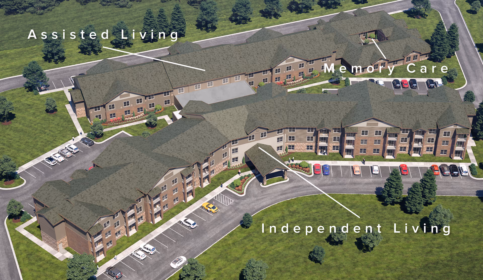 Aerial view of The Wildwood Senior Living facility showing three main sections labeled Assisted Living, Memory Care, and Independent Living. The buildings are surrounded by green lawns, trees, and parking areas with cars.