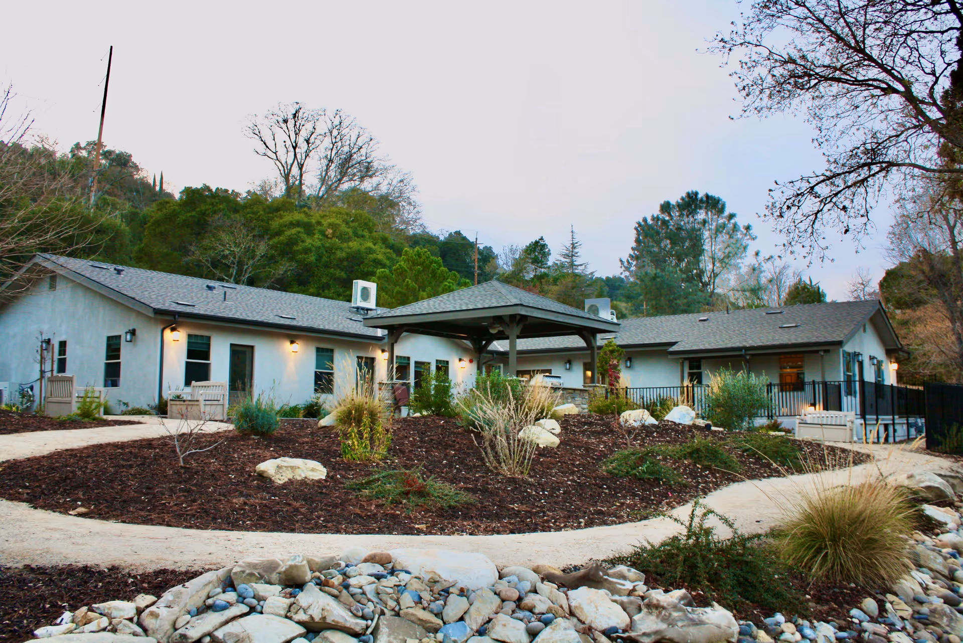 Single-story assisted living campus with a central gazebo and landscaped outdoor courtyard.