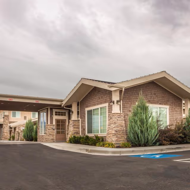 Ashford Assisted Living & Memory Care building exterior with stone facade and driveway.