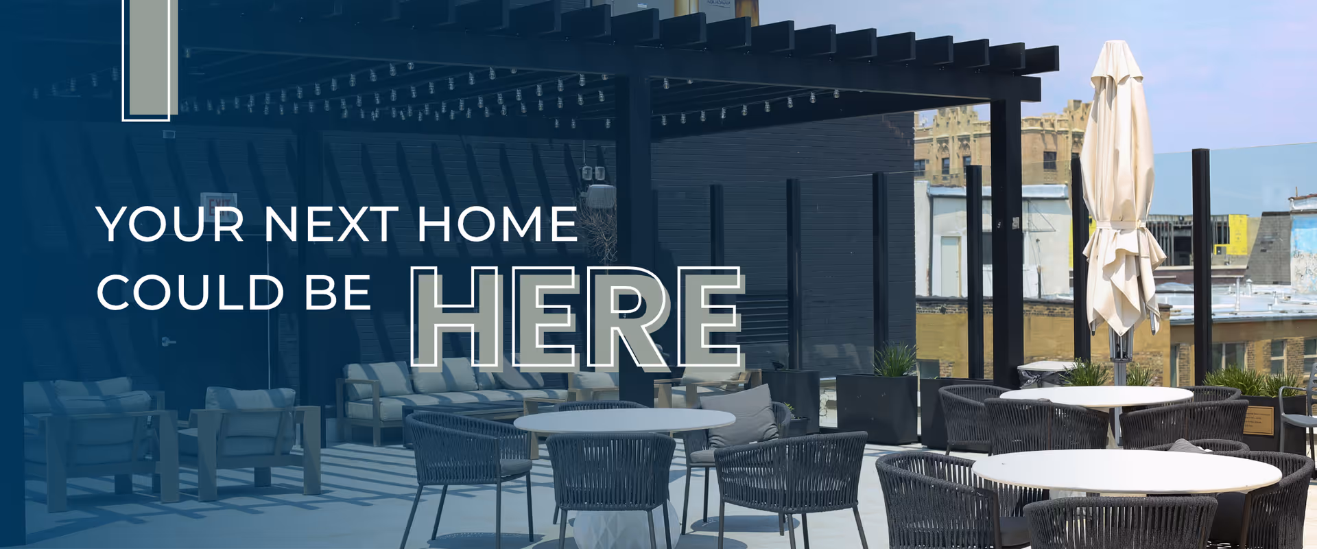 Outdoor patio area with round tables and chairs under a pergola, with a folded umbrella and buildings visible in the background. Text overlay reads 'YOUR NEXT HOME COULD BE HERE'.