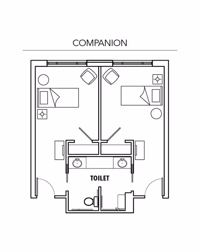 Architectural floor plan labeled 'COMPANION' showing two adjacent bedrooms each with a bed, nightstand, and chair. Both rooms share a central bathroom area labeled 'TOILET' with two sinks, a toilet, and a shower.