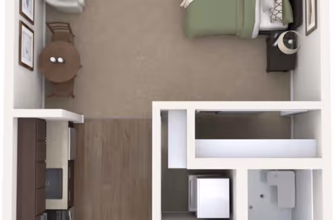 Top-down floor plan of a studio apartment showing a bed, small dining table, kitchenette, and bathroom.