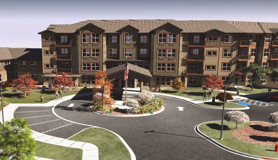 Exterior view of a multi-story senior living building with a circular entrance driveway.