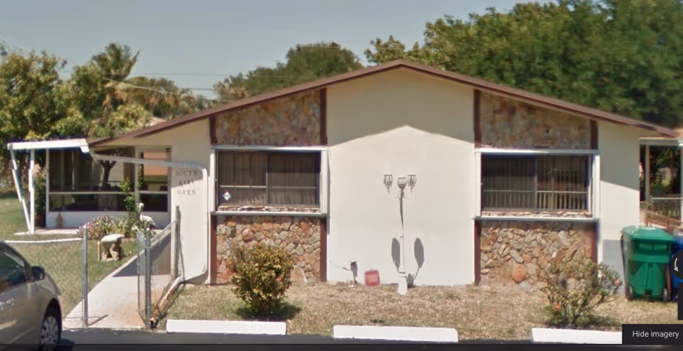 South Oaks ALF exterior: single-story building with stone-and-white facade and front entrance.