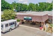 Exterior view of Niles Care Center with a bus parked in front of the entrance.