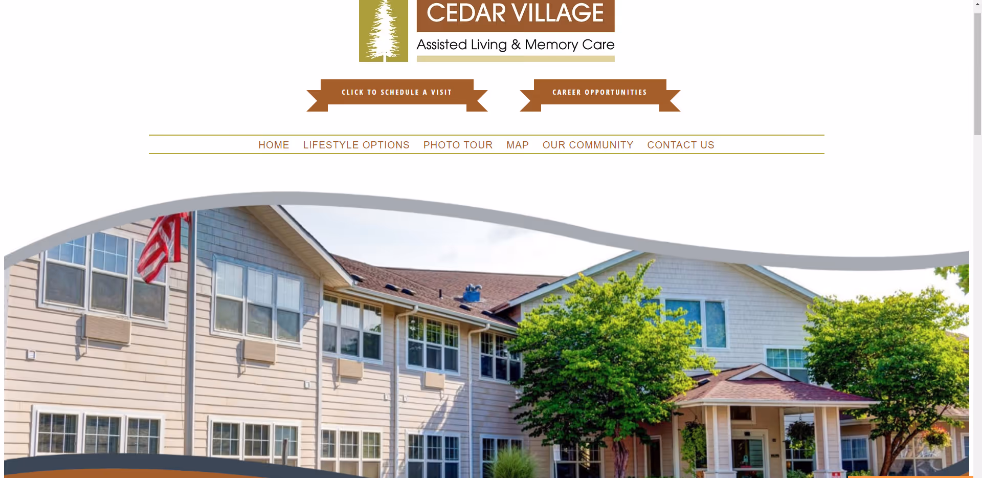 Front exterior of Cedar Village assisted living building with trees and an American flag.