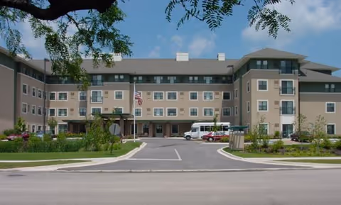 Front view of Cordia Senior Residence Westmont building with entrance, driveway, and landscaping