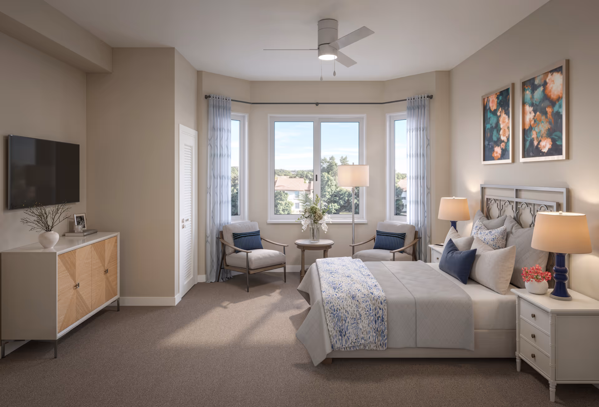 Bright furnished bedroom with a bed, nightstands, seating area by bay windows, a wall-mounted TV and decorative artwork.