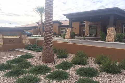 Exterior view of Mosaic Gardens Memory Care at Chandler with desert landscaping and entry canopy.