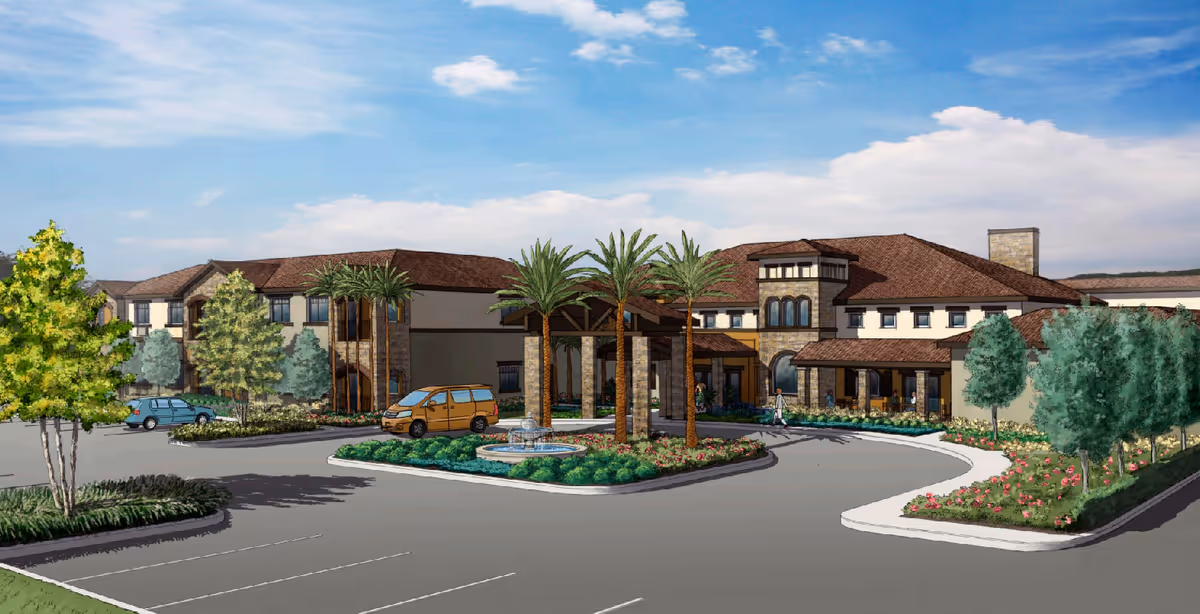 Exterior view of a senior living facility named Pacific Adult Care, showing a large building with a tiled roof, palm trees, a circular driveway with a fountain in the center, and landscaped greenery around the parking area under a partly cloudy sky.