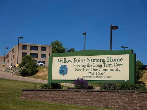 Exterior of Willow Point Nursing Home with sign and landscaped grounds