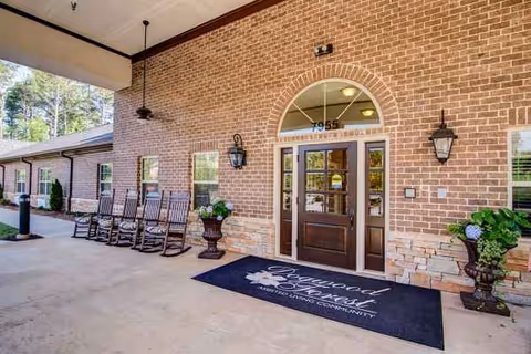Brick entrance to Oaks at Shiloh Point with rocking chairs outside.