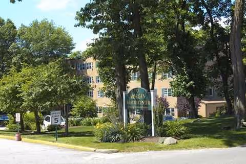 Exterior view of Morgan Rehabilitation and Healthcare Center with trees and signage.