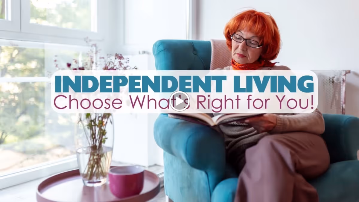 An elderly woman with red hair and glasses is sitting comfortably in a teal armchair by a large window, reading a book. A small round table next to her holds a vase with flowers and a purple cup. Text overlay reads 'INDEPENDENT LIVING Choose What's Right for You!'
