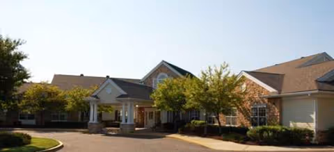 Front exterior of Brookdale Westampton senior living facility with entrance and trees.