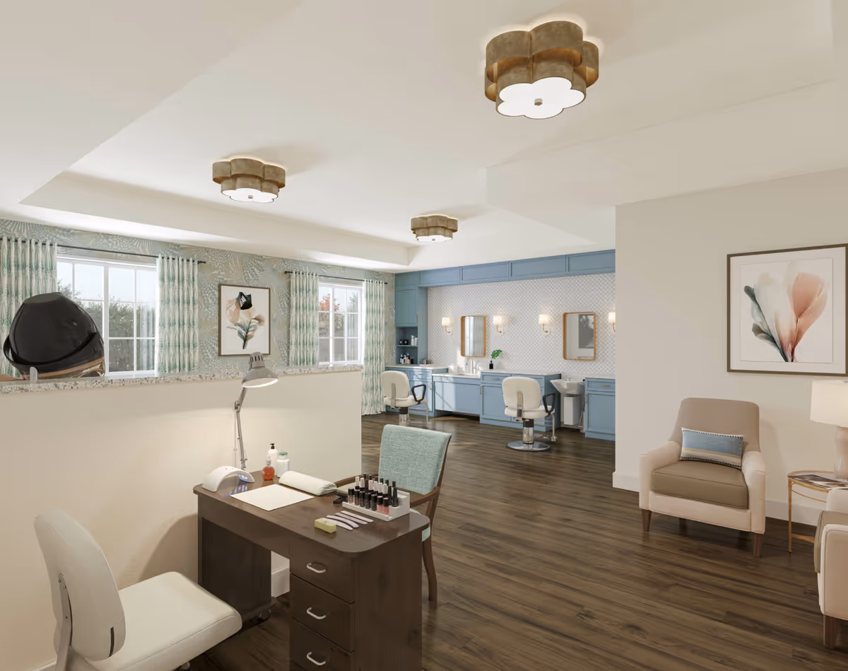 Bright interior salon area with a manicure station in the foreground and hair styling chairs and counters in the background.