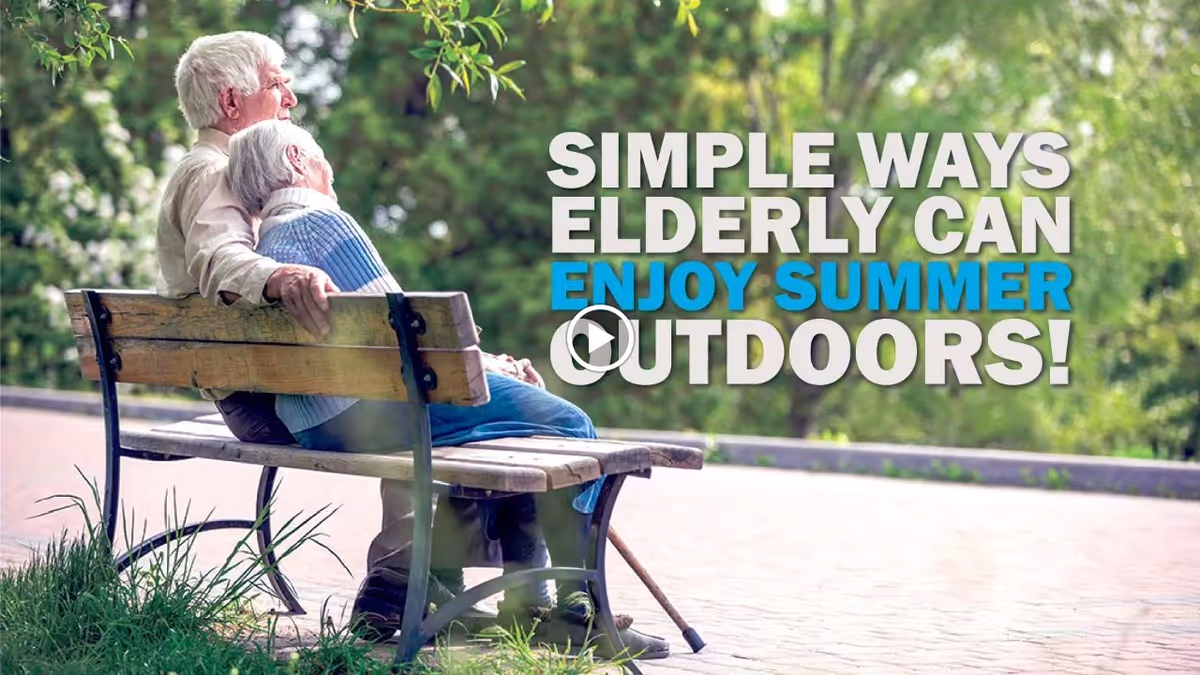 An elderly couple sitting closely together on a wooden bench in a park surrounded by greenery, with the man resting his arm on the back of the bench and the woman leaning on him.