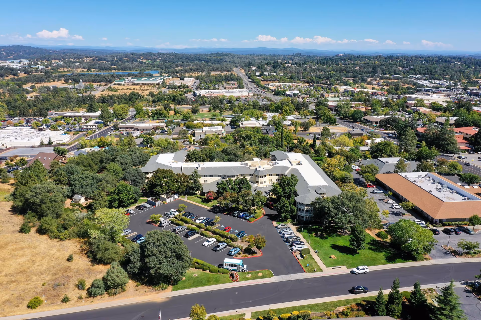 Aerial view of the Solstice Senior Living building with its parking lot, lawns, and surrounding suburban neighborhood.